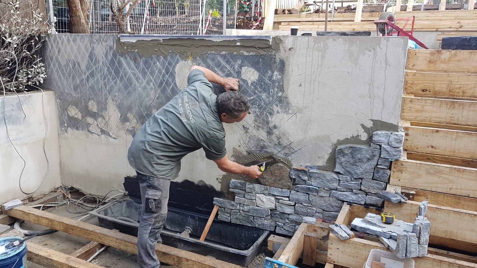 During construction - stone cladding being installed on the feature wall in the Greenwich backyard