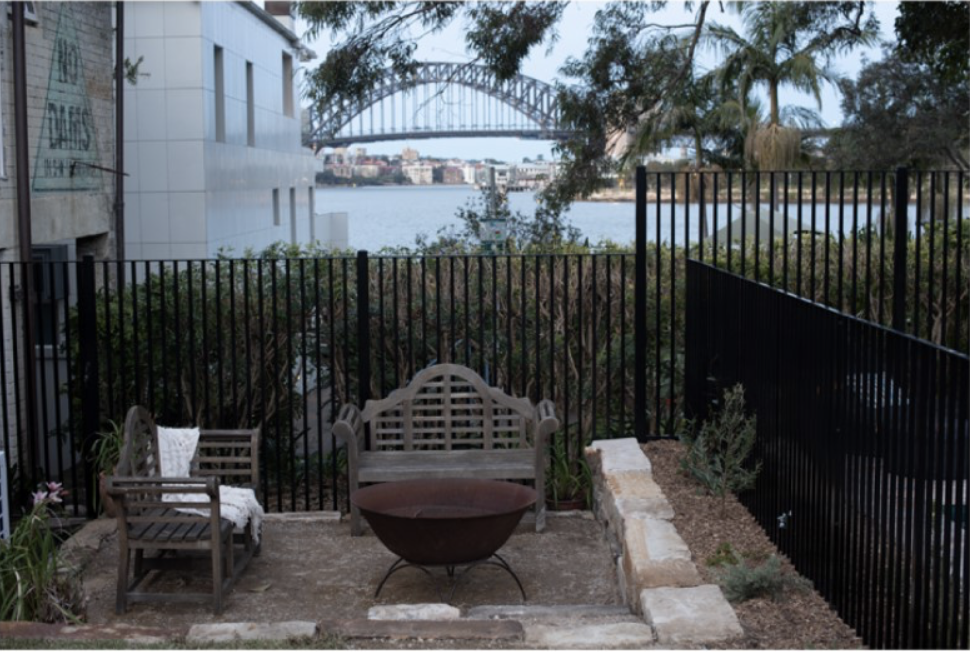 Fire pit courtyard with timber benches and views to the Sydney Harbour Bridge
