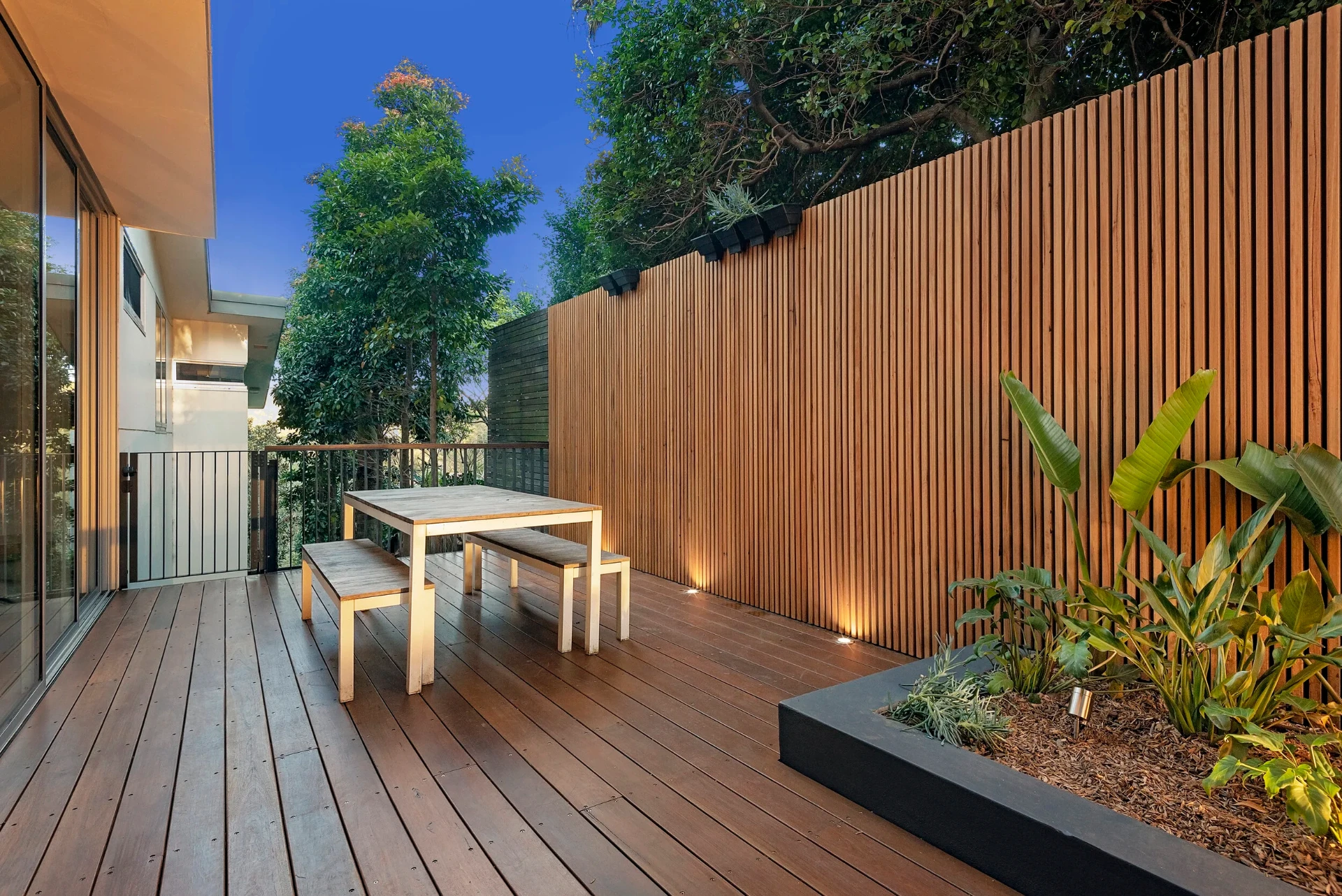Greenwich side deck with vertical hardwood privacy screen, integrated lighting and planter box