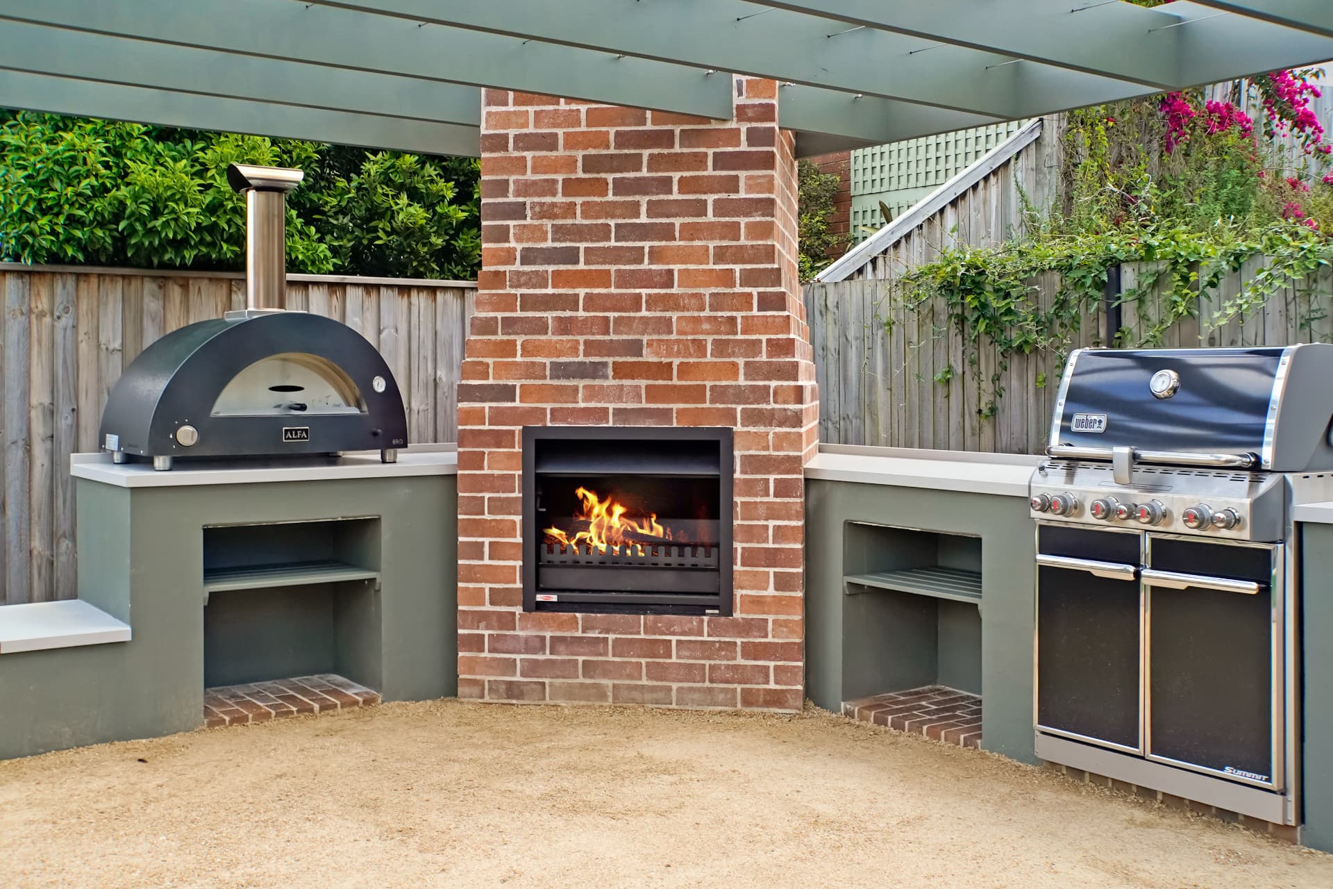 Wide view of the completed outdoor kitchen, fireplace and BBQ under the pergola at Haberfield