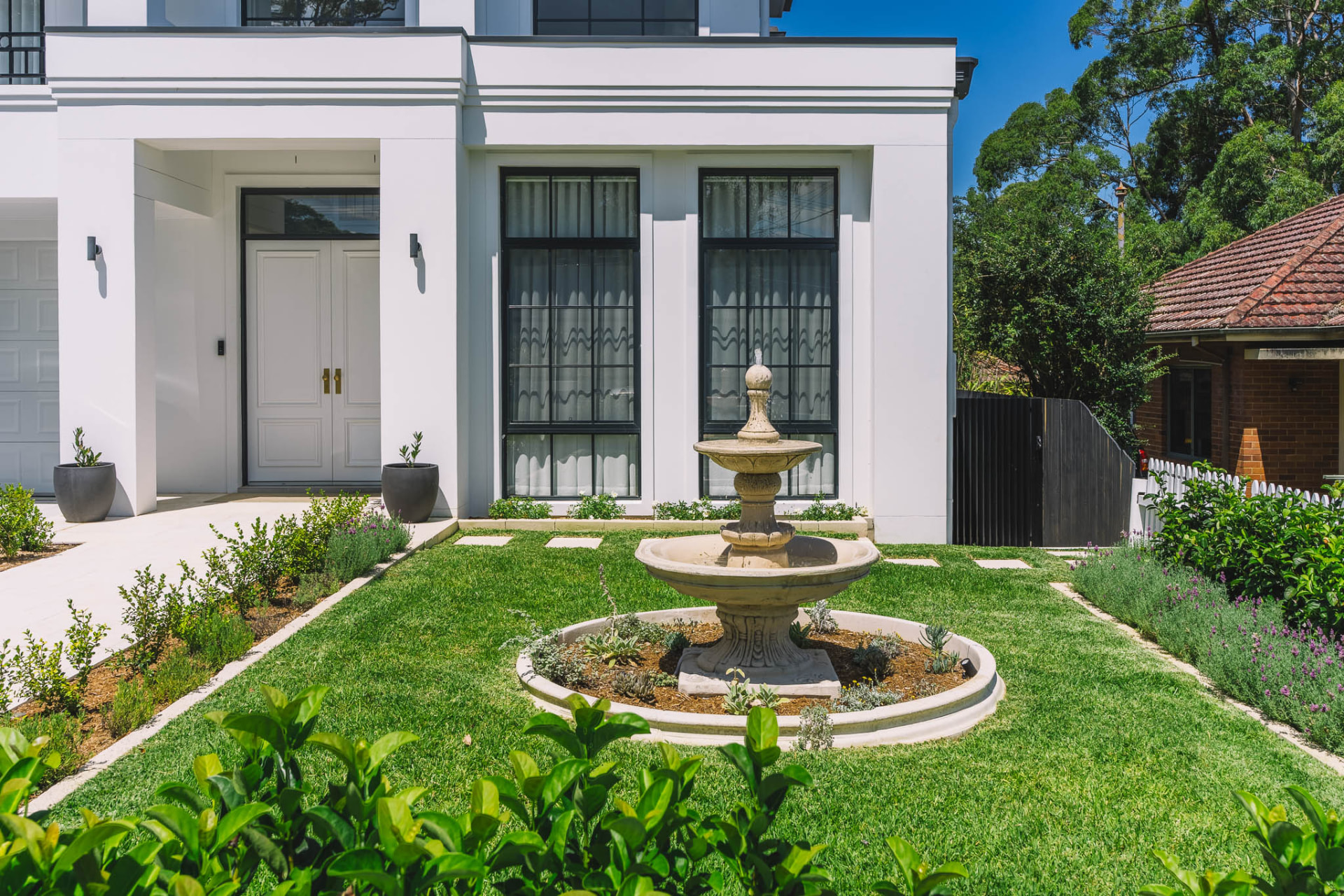 Chatswood front garden with tiered stone fountain, stepping stones and new lawn at the entry