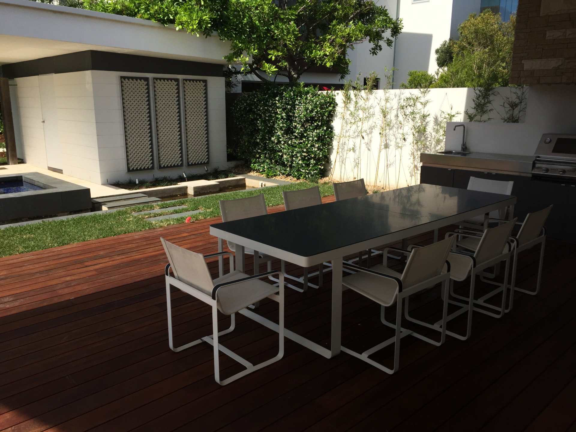 Outdoor dining table on the timber deck beside the pavilion kitchen at Dover Heights