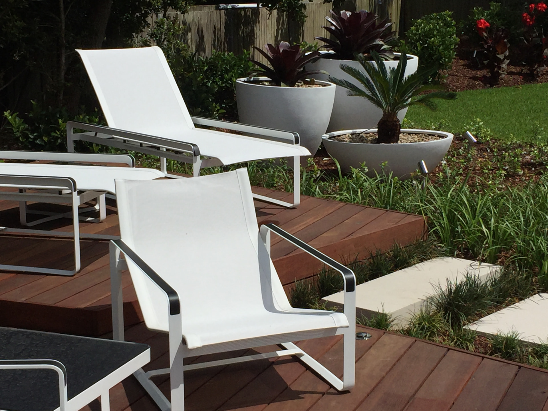 White loungers on the Dover Heights decking tiers with planter pots and new gardens