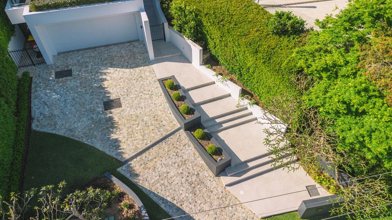 Aerial view of the Northbridge cobblestone driveway, entrance stairs and garden planters