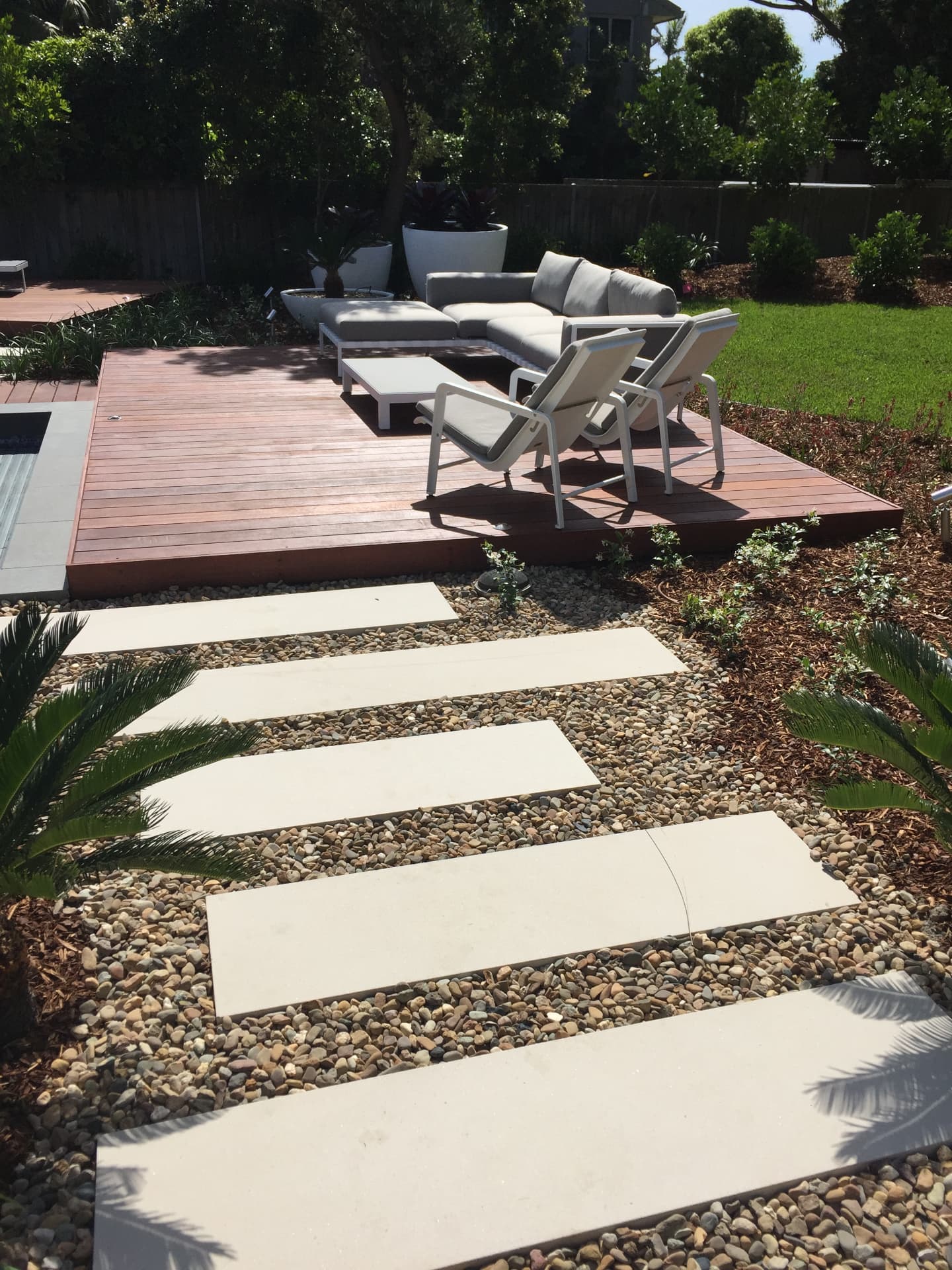 Outdoor lounge suite on the hardwood deck with step stone path at Dover Heights