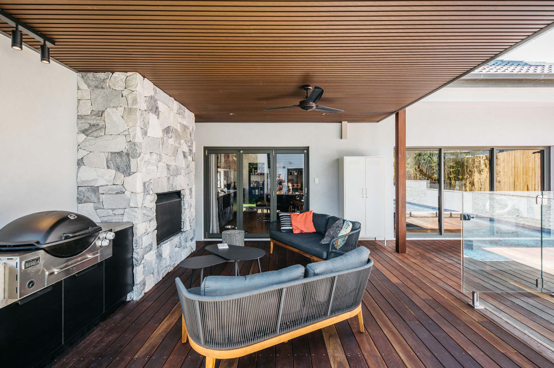 Freshwater outdoor room with timber deck, stone fireplace, barbecue and pool access