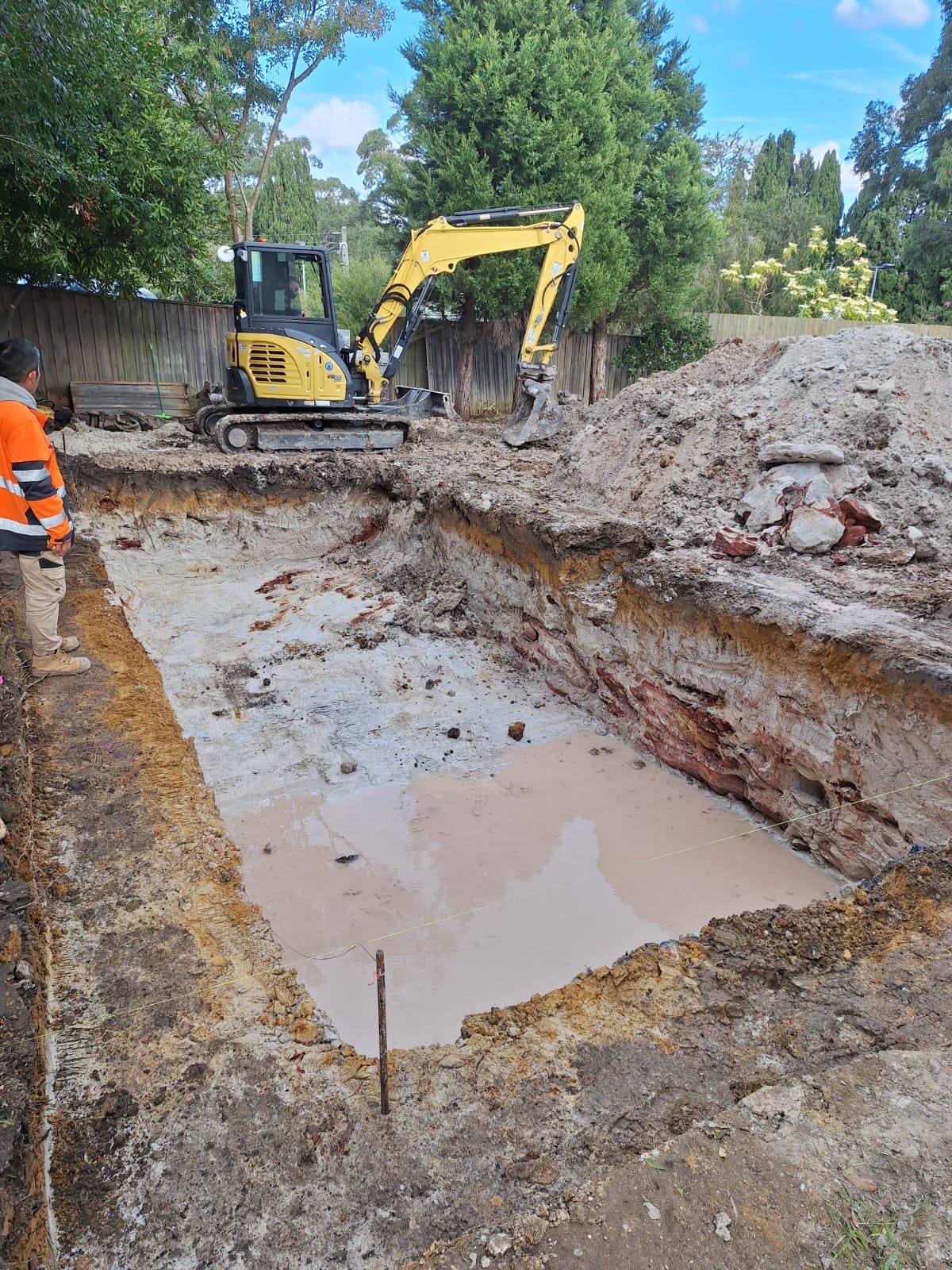 Before - excavator digging the pool pit in the Chatswood backyard before construction began