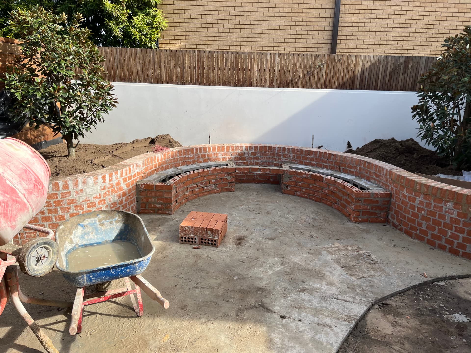 Before - curved brick bench seating under construction in the Wareemba backyard