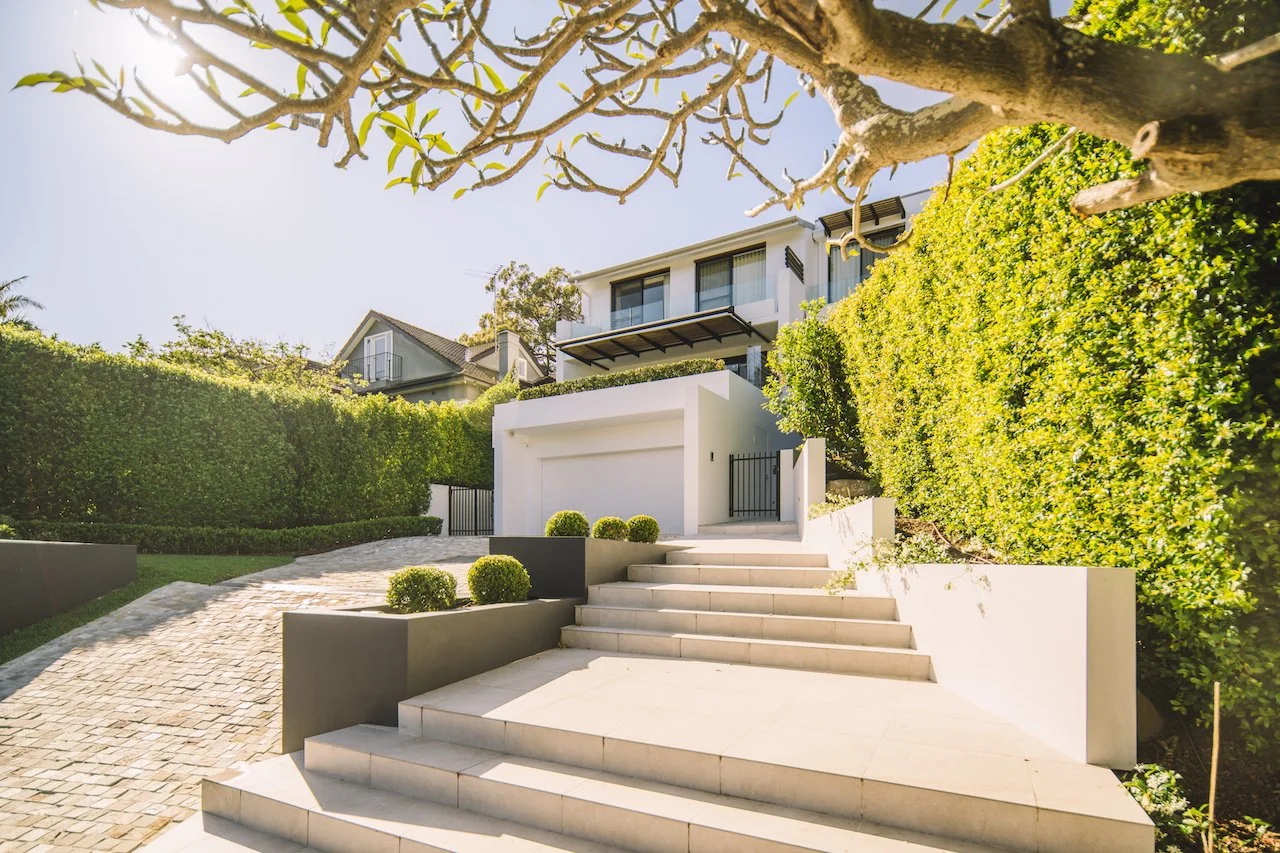 Wide view of the Northbridge entrance steps, rendered walls and cobblestone driveway