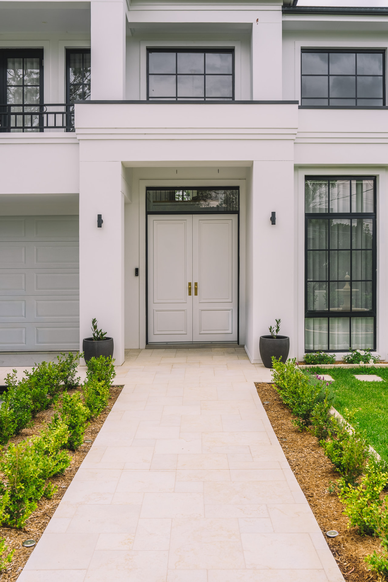 Limestone entry path with clipped hedging leading to the front door of the completed Chatswood home