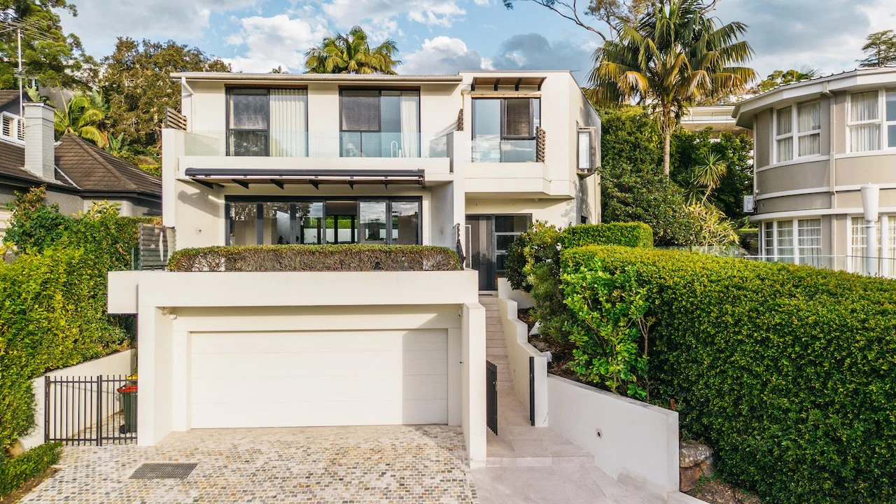 Northbridge home frontage with cobblestone driveway, garage and landscaped entrance