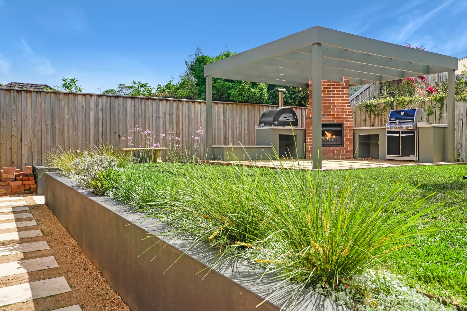 Deco granite courtyard, new turf and gardens surrounding the Haberfield outdoor kitchen