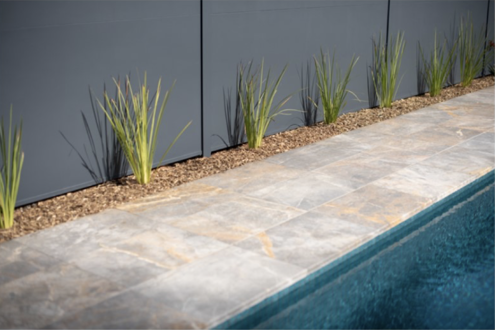 Poolside paving with new planting along the boundary fence