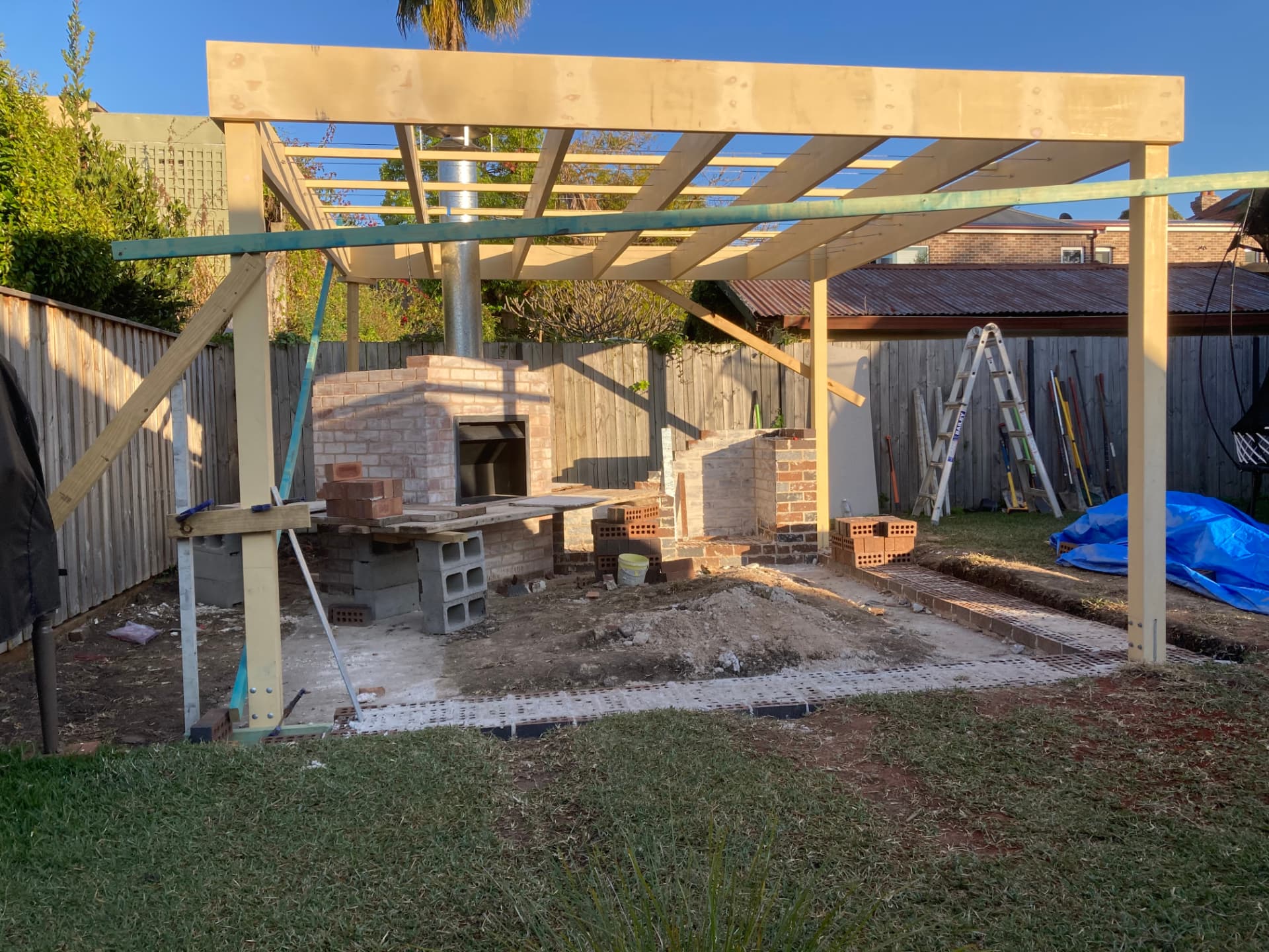 Before - timber pergola frame and brick fireplace under construction in the Haberfield backyard
