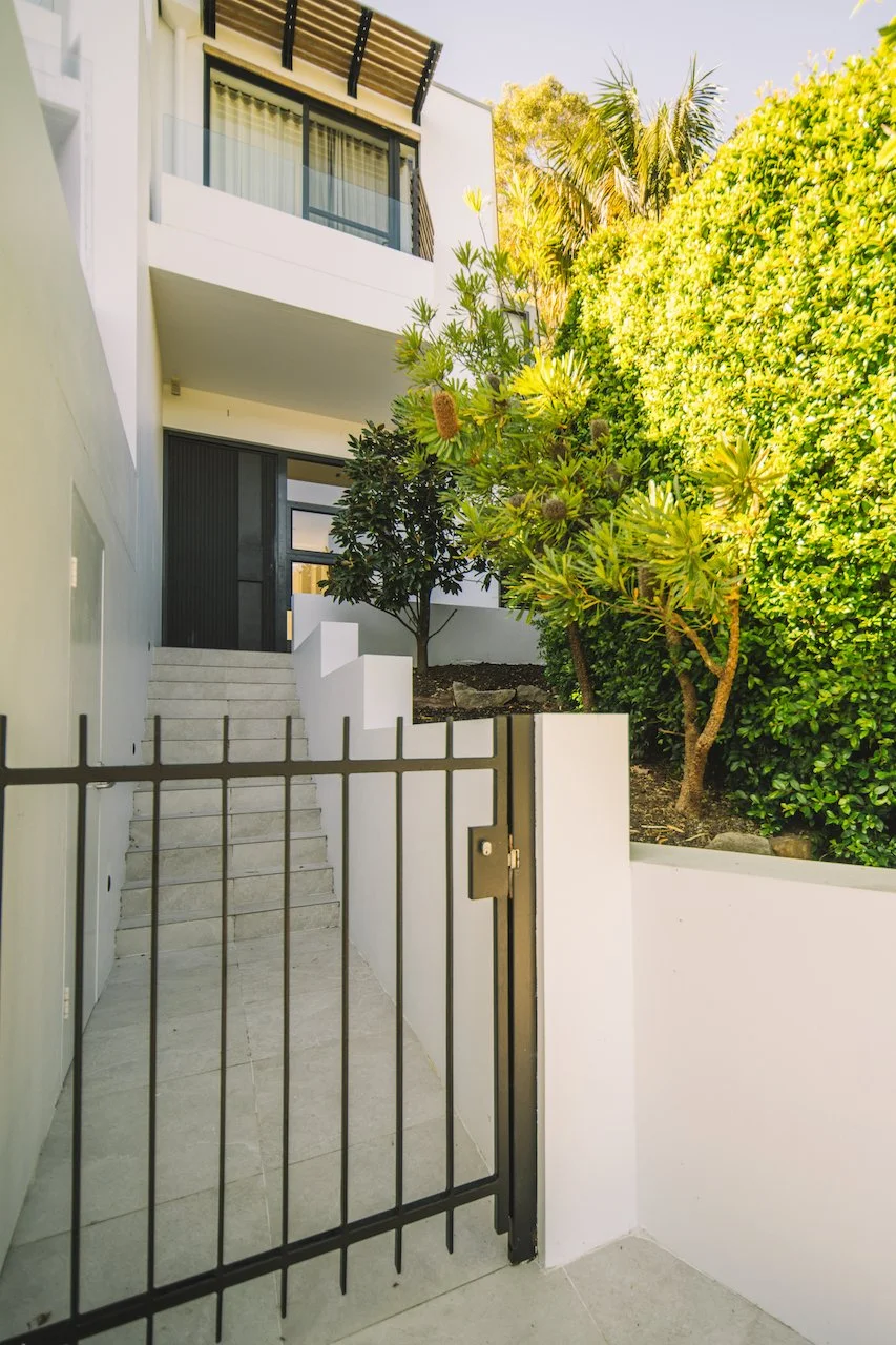 Northbridge pedestrian entry gate, tiled path and restored entrance planting