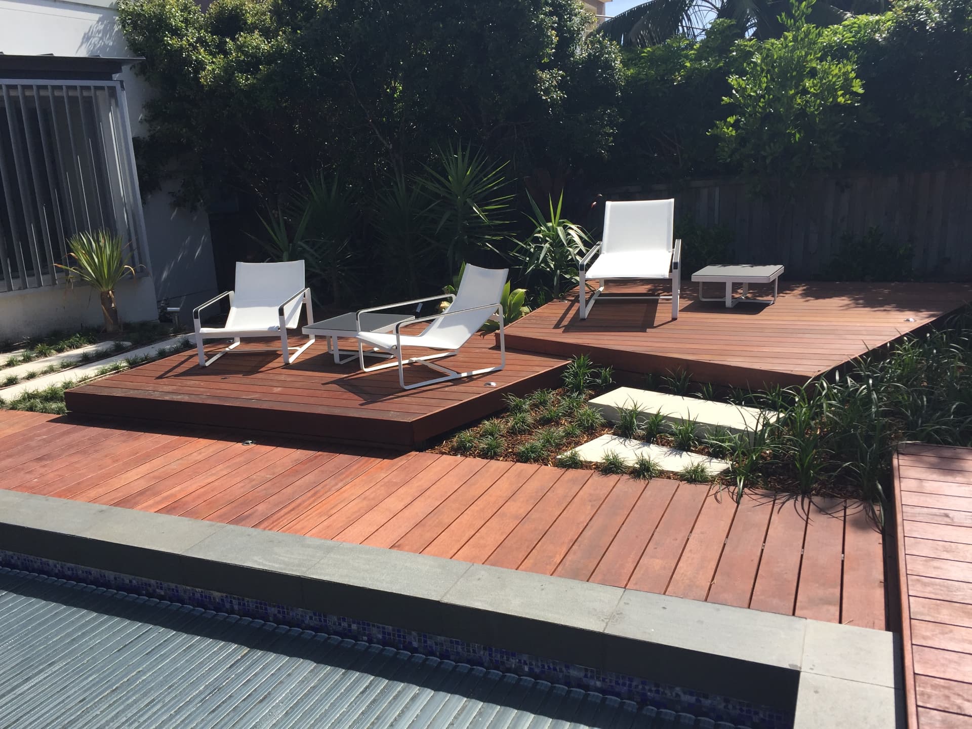 Sunny view across the Dover Heights decking tiers, pool and new gardens