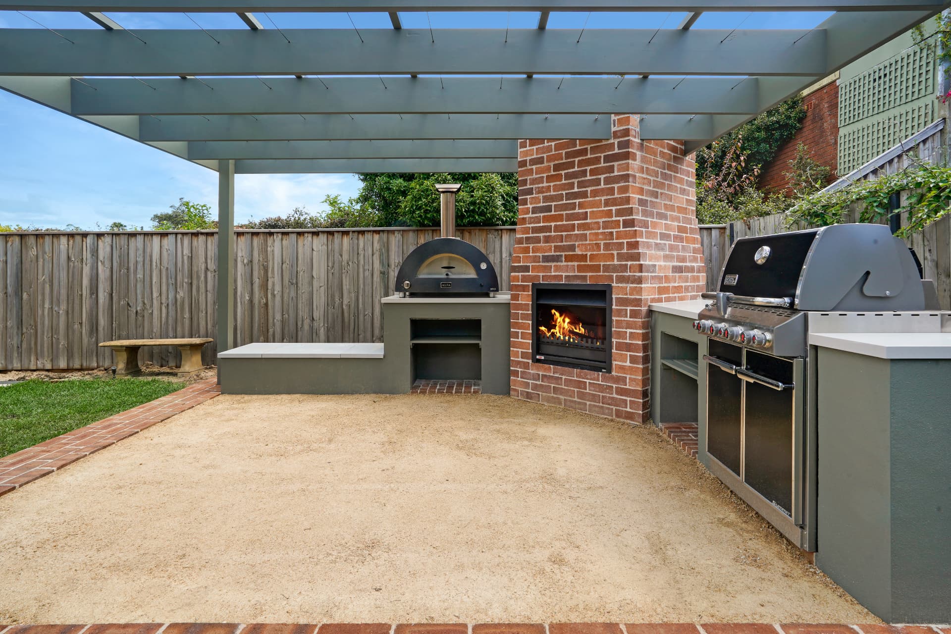Timber pergola over the outdoor kitchen with pizza oven, fireplace and BBQ bench tops in Haberfield