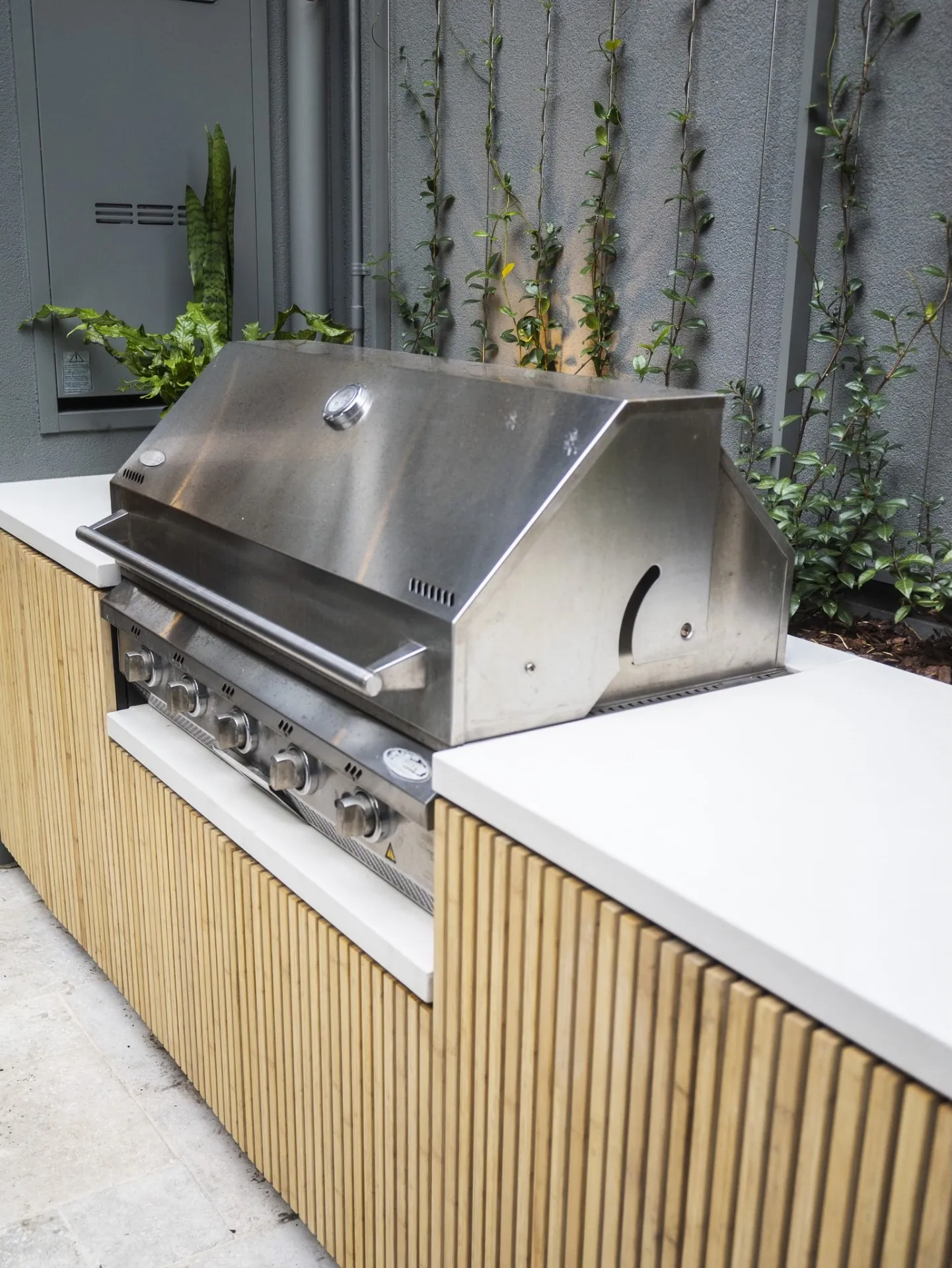 Detail of natural stone paving and timber screening in a Sydney courtyard
