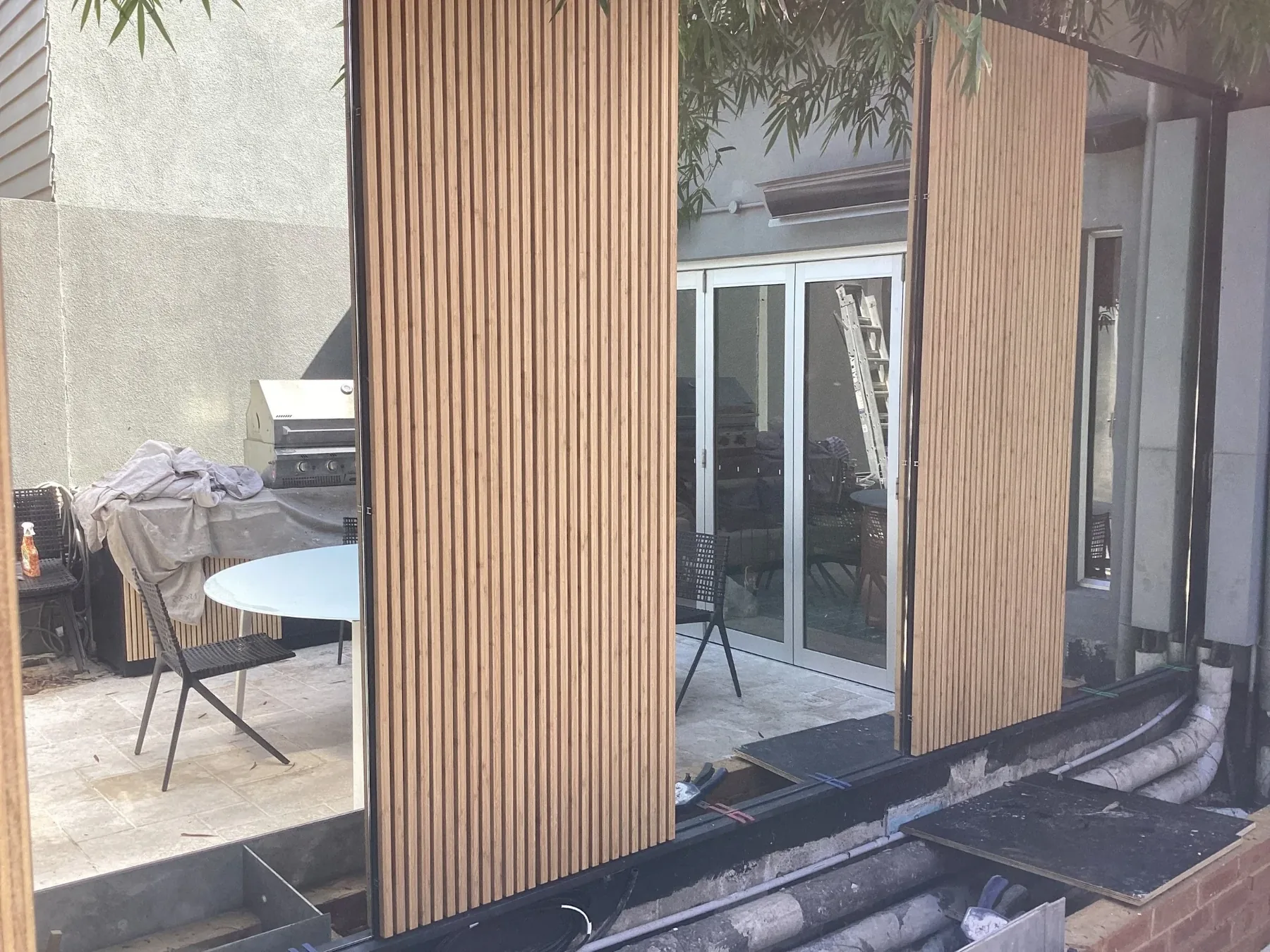 During construction - timber cladding panels being installed over the existing doors