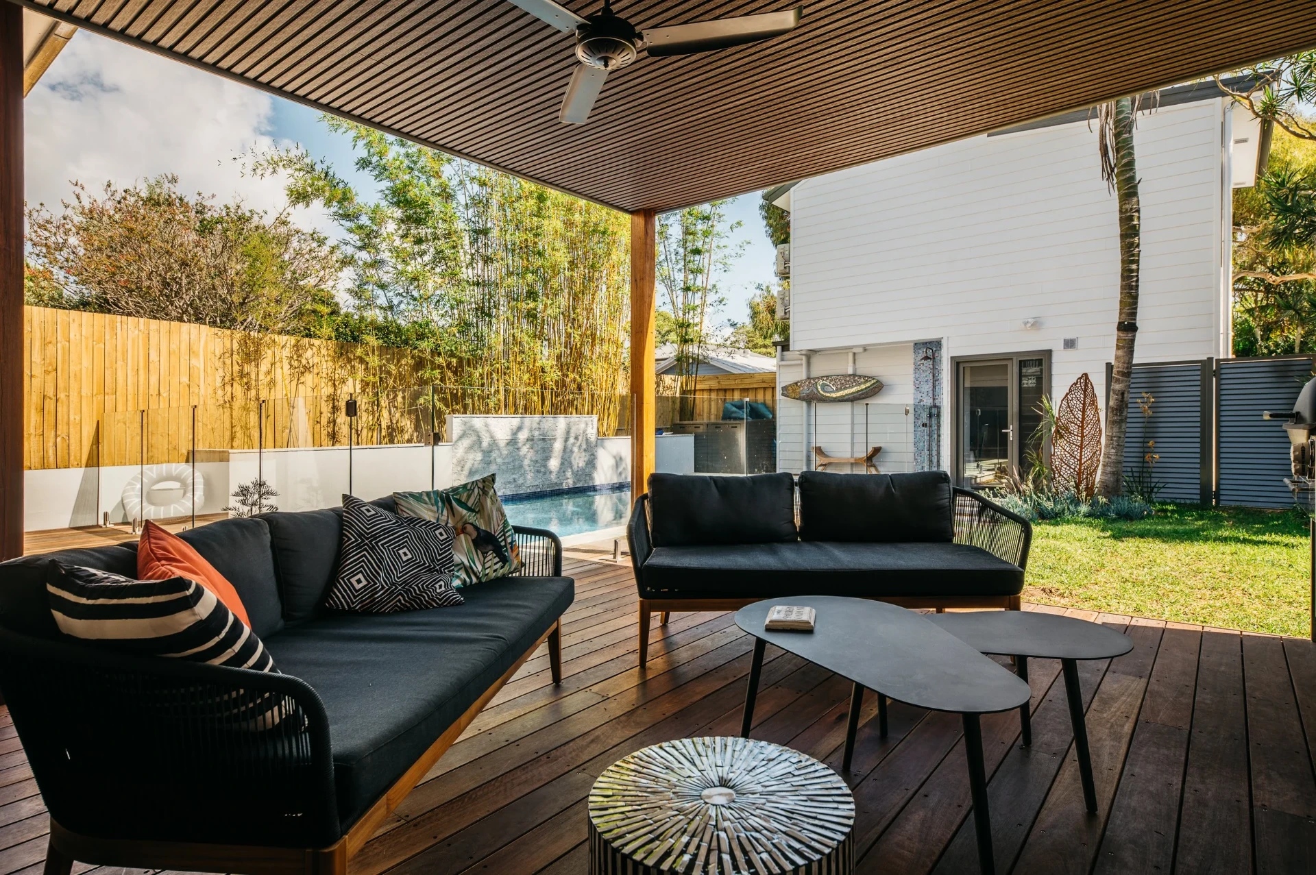 Freshwater outdoor room lounge on hardwood decking looking out to the renovated pool