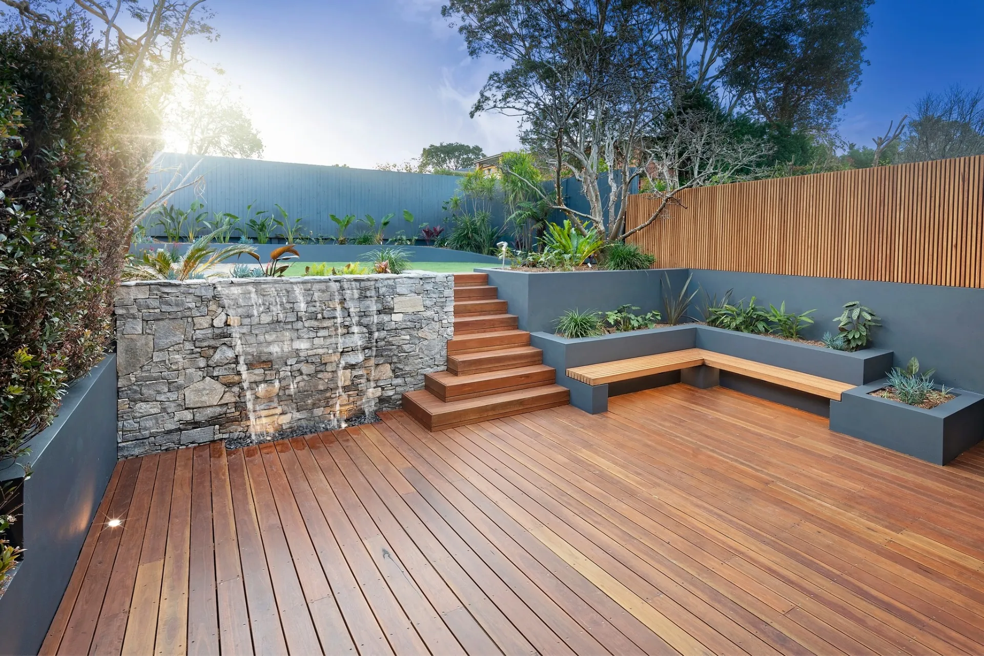 Completed ironbark deck with stone waterfall and built-in bench seating