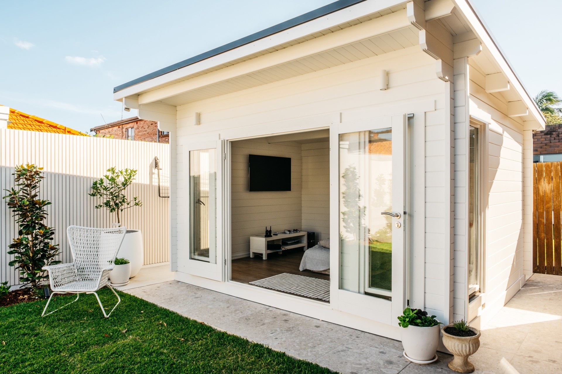 Daytime view of the cabana with bifold doors open to the courtyard