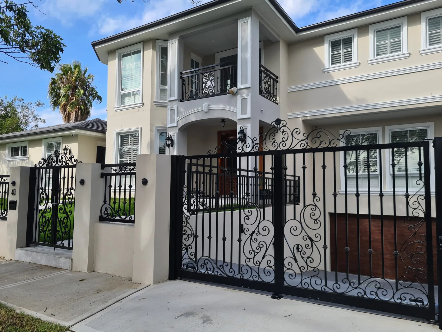 Custom driveway and pedestrian gates set into rendered piers at the Killara frontage