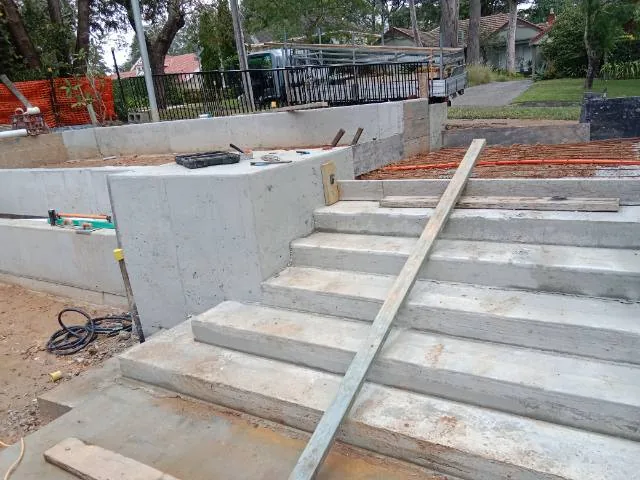 During construction - engineered concrete retaining walls and formed entry stairs