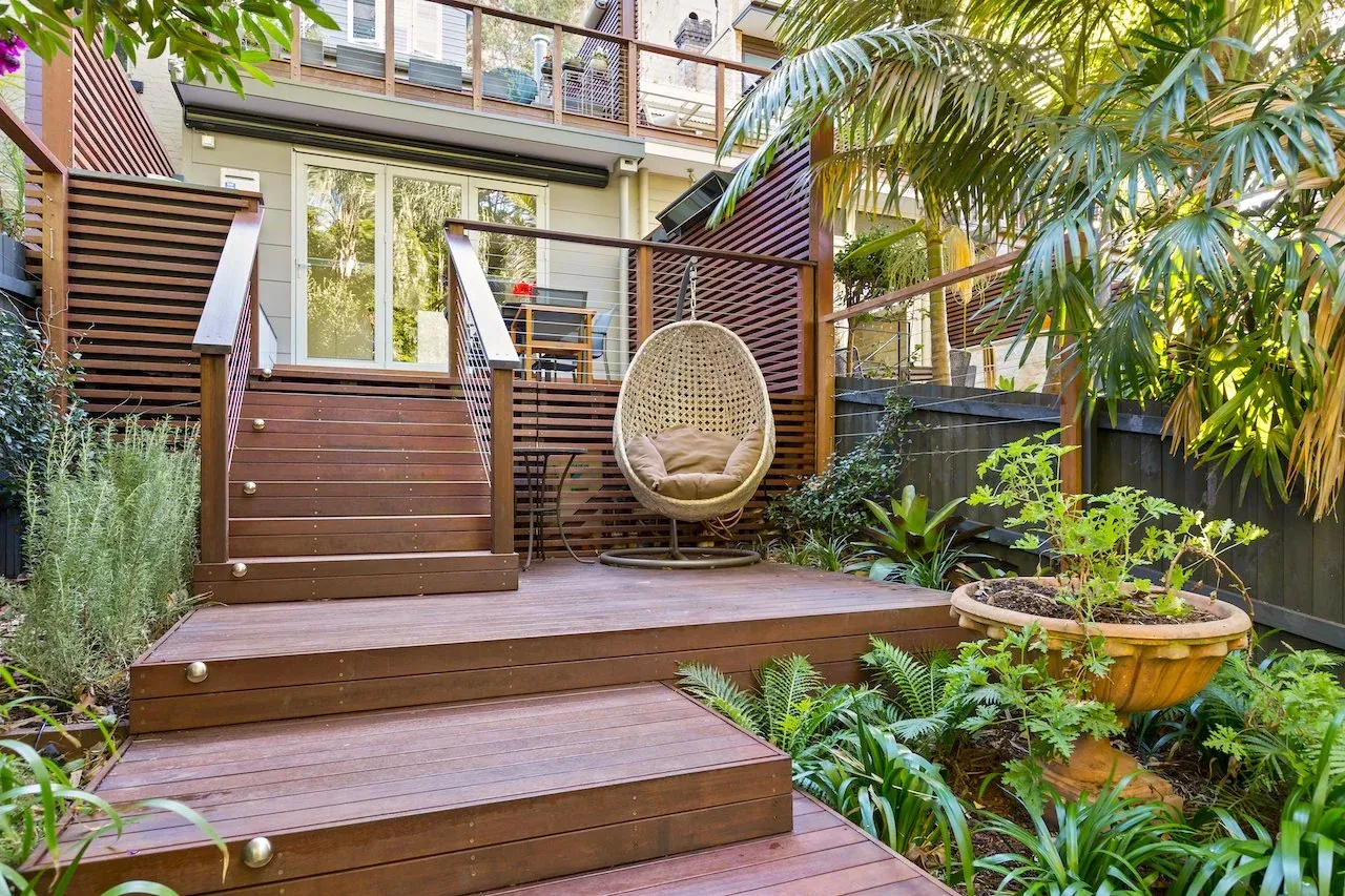 Hardwood timber deck with wide steps, hanging chair and horizontal screening