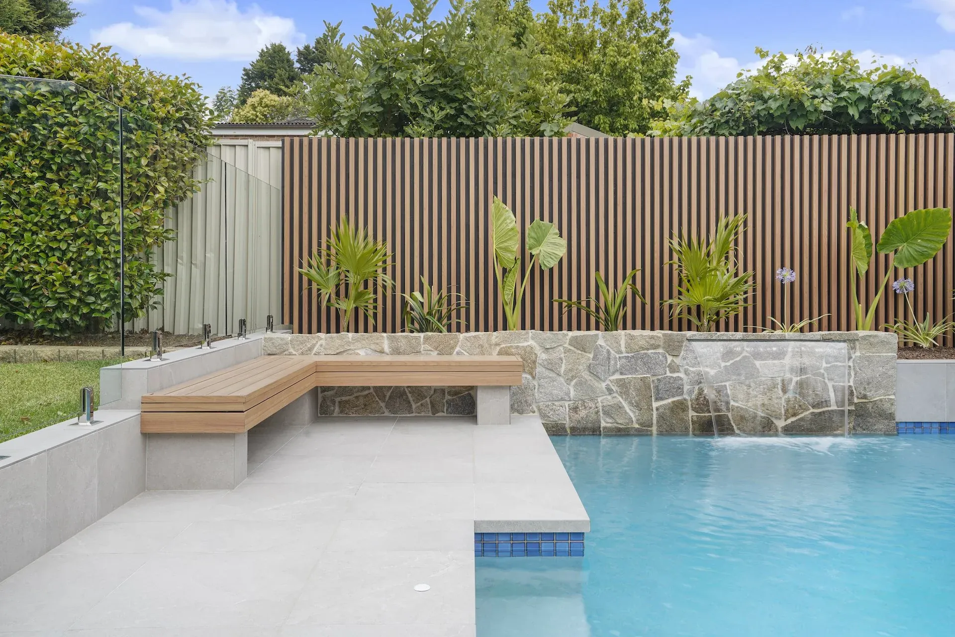 Built-in bench seat set into the rendered wall beside the level lawn