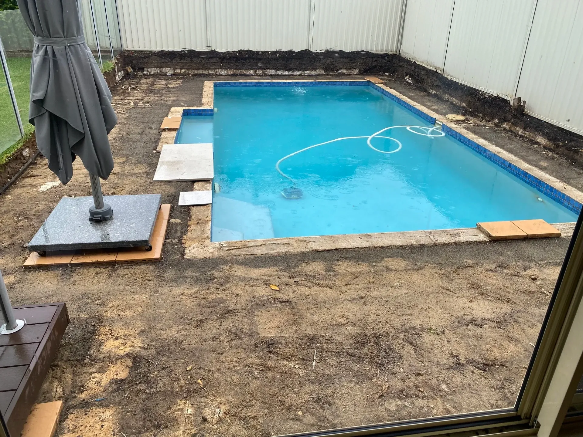 Before - original pool with surrounds demolished back to bare ground