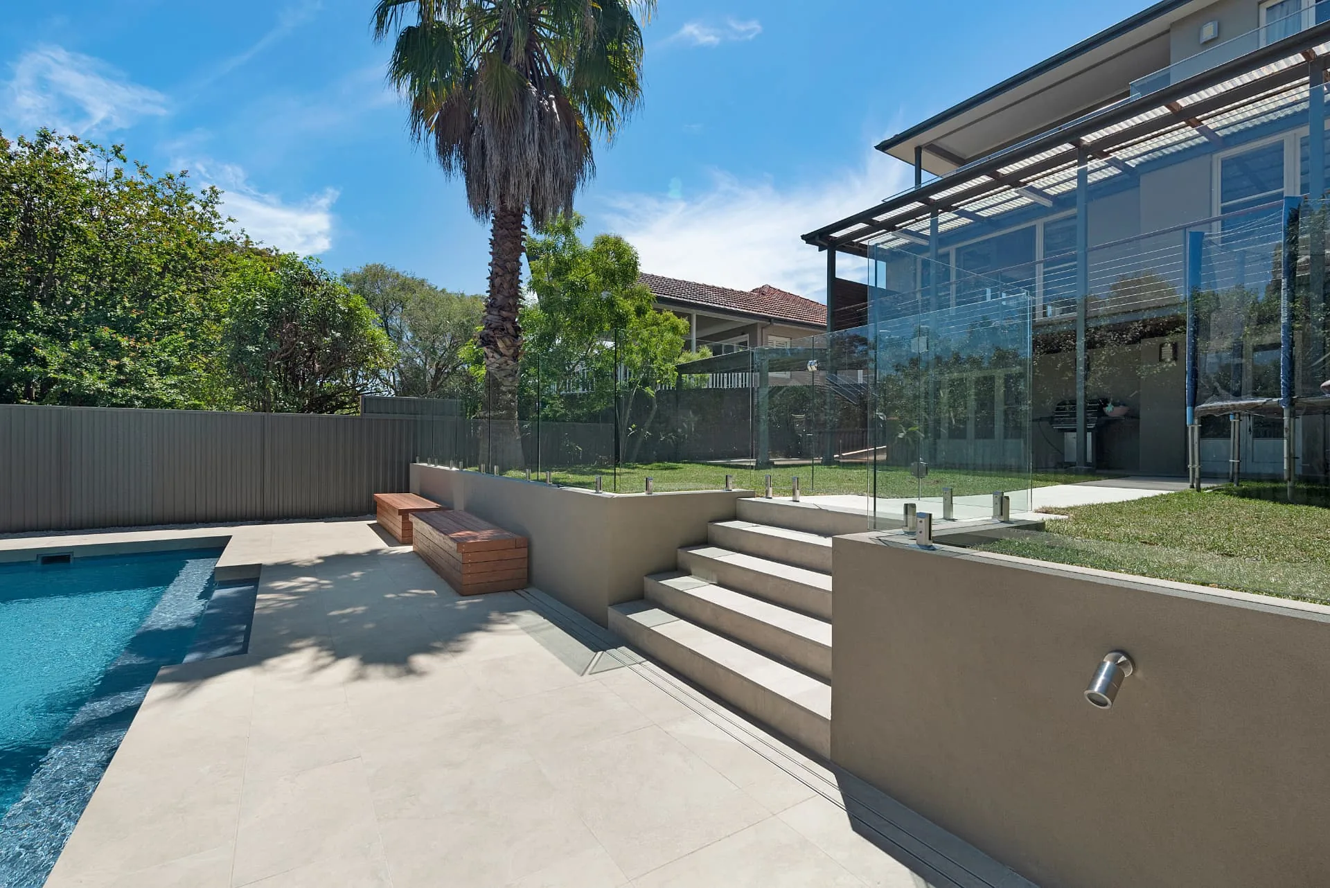 Wide stairs linking the Riverview pool terrace up to the level lawn