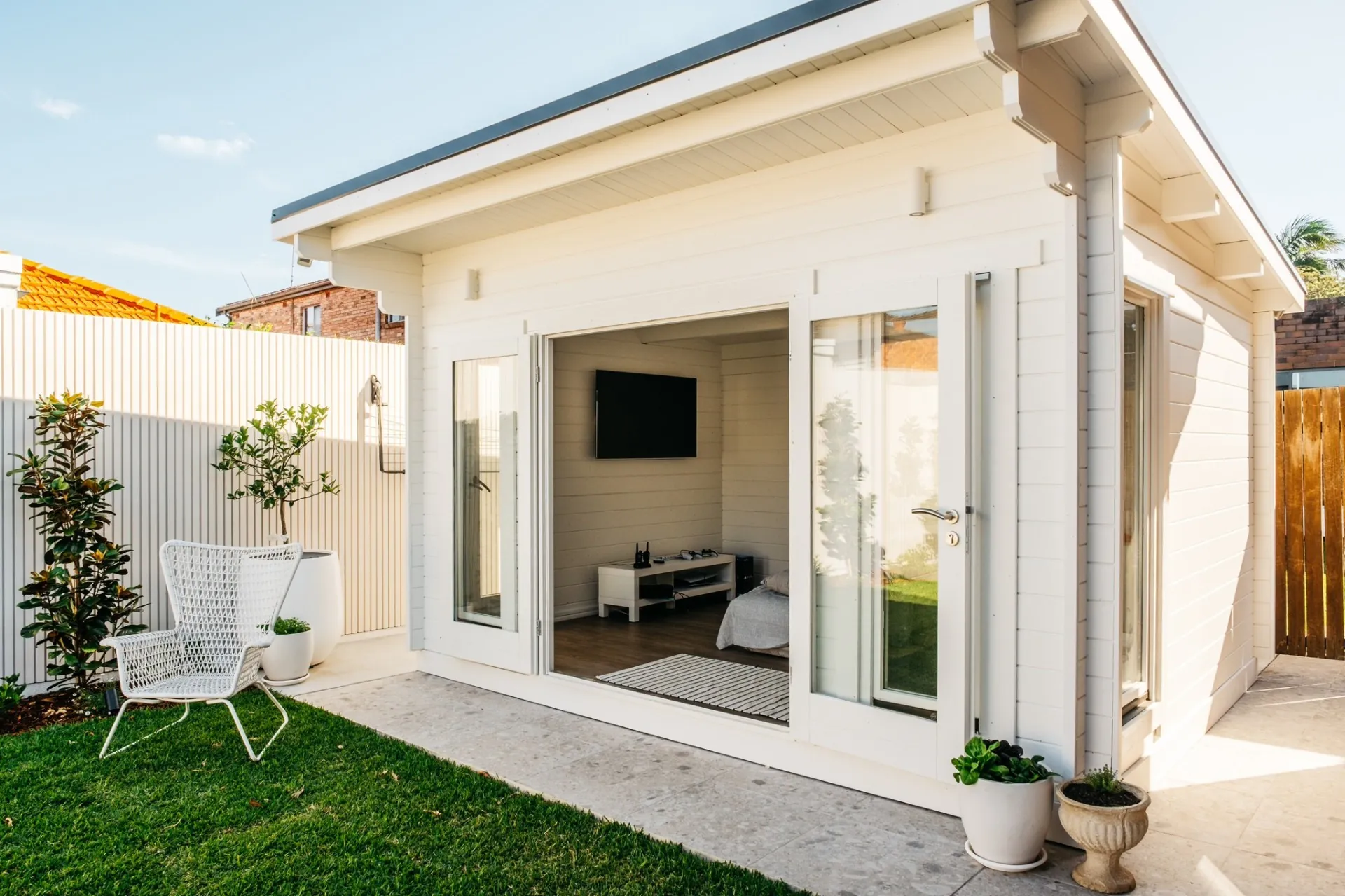 Daytime view of the cabana with bifold doors open to the courtyard