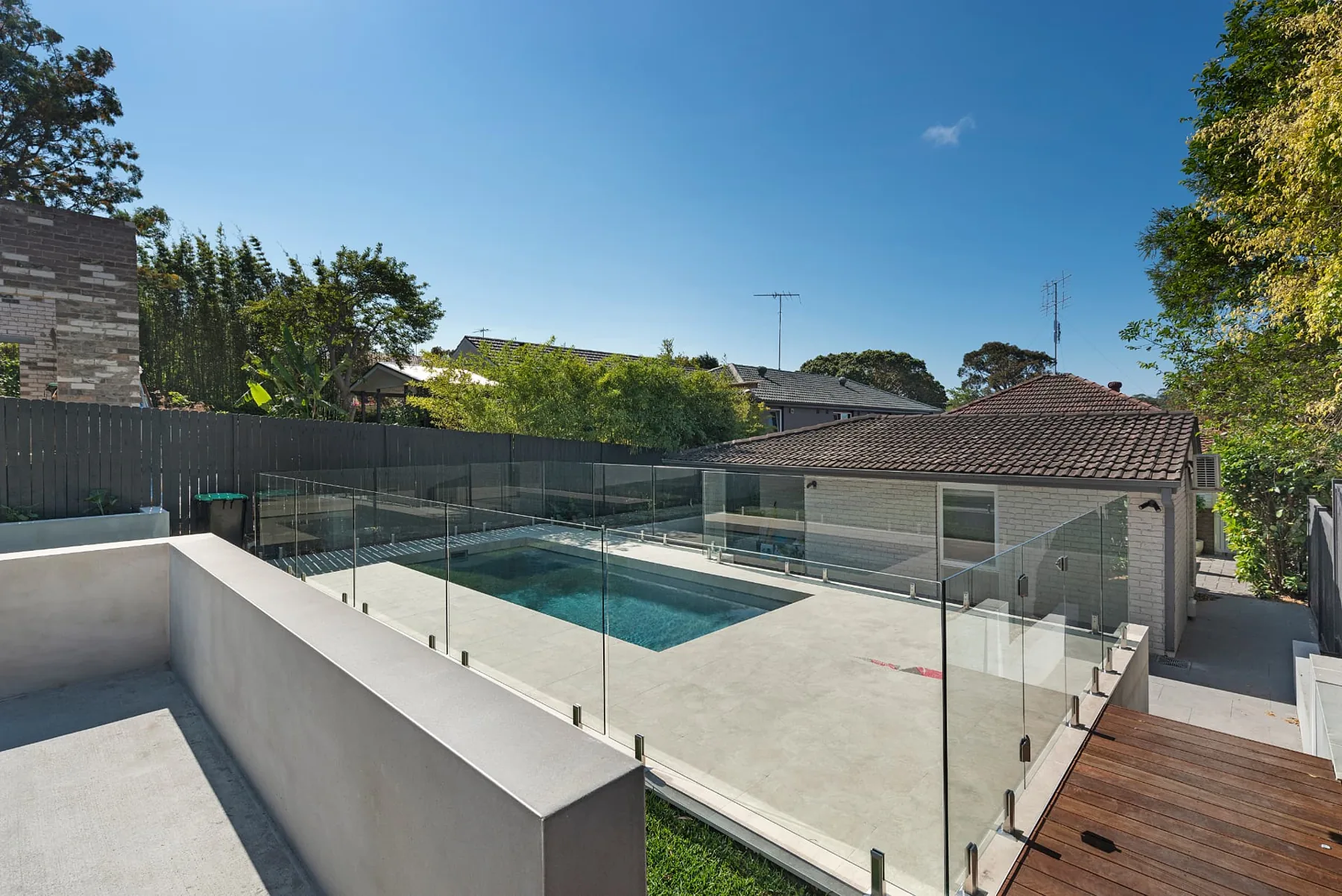 Elevated view of the Seaforth pool terrace, lawn and hardwood deck landing