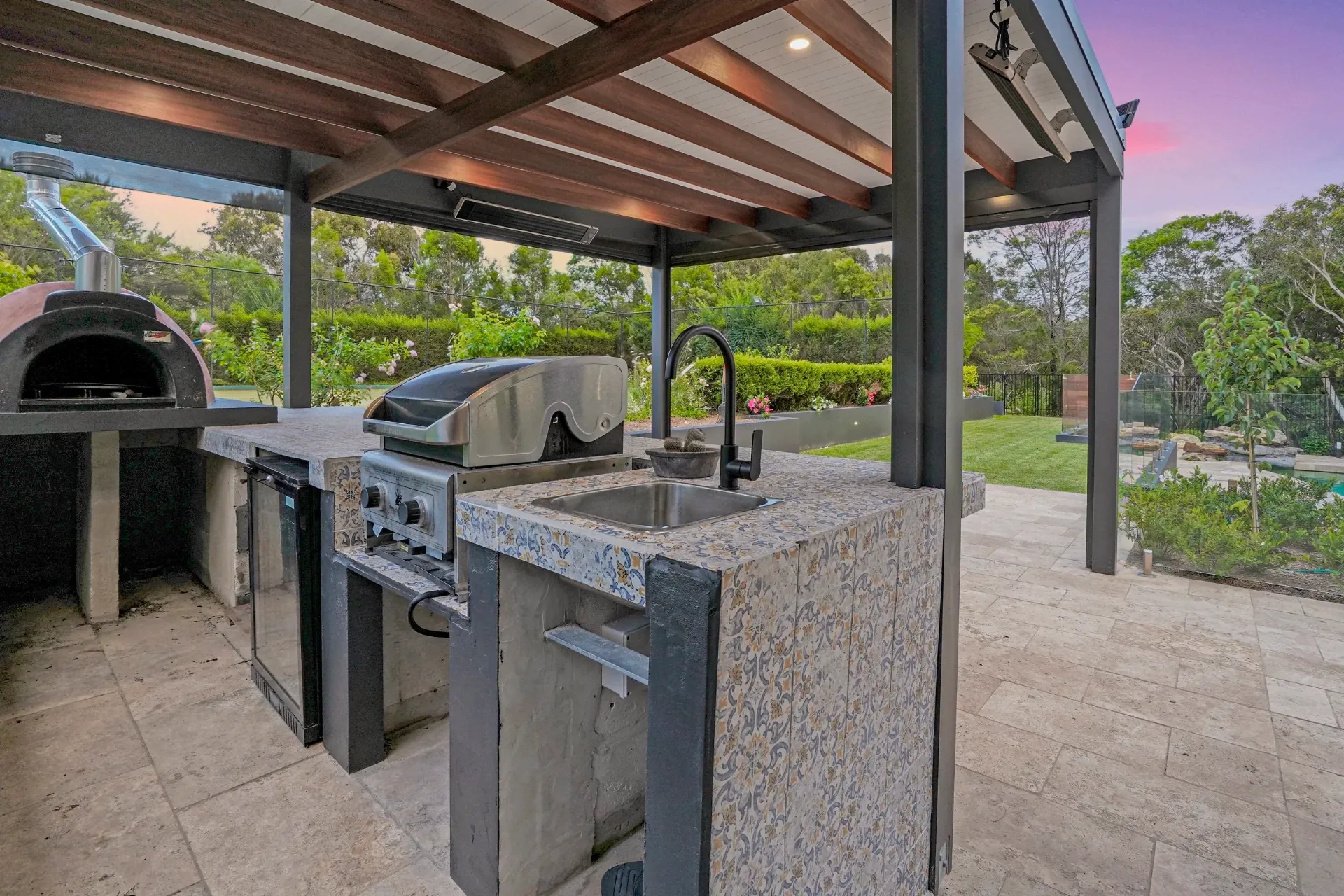 Outdoor kitchen with built-in barbecue, benchtop and under-cover entertaining space